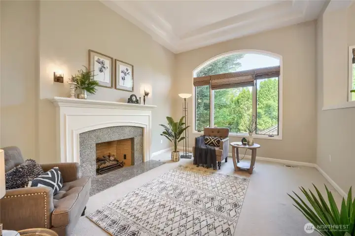 High ceilings and plenty of light along with a cozy fireplace.