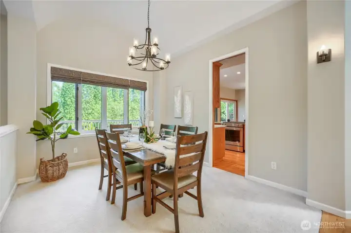Dining room off the kitchen with high ceilings and light.