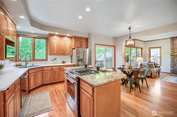 Bright kitchen with new quartz countertops, large island, stainless steel appliances, solid oak and glass cabinets, and pantry that inspires culinary creativity.