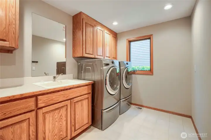 Laundry room with ample space for folding and storage.