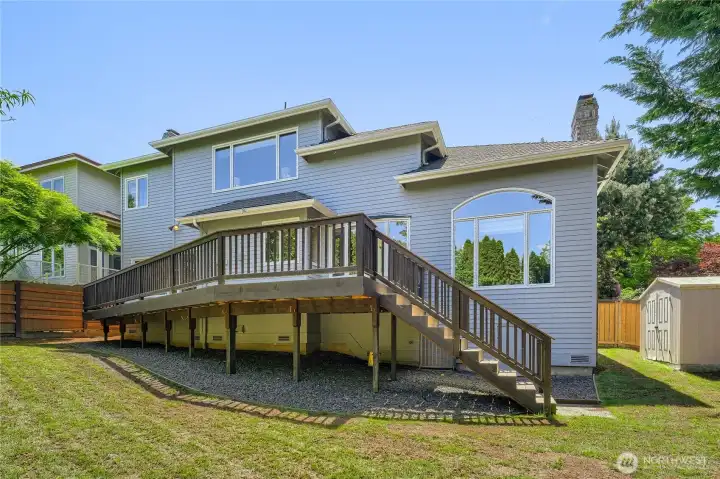 Sprinkler system, re-landscaped level backyard, with new Trex deck and new cedar fence.