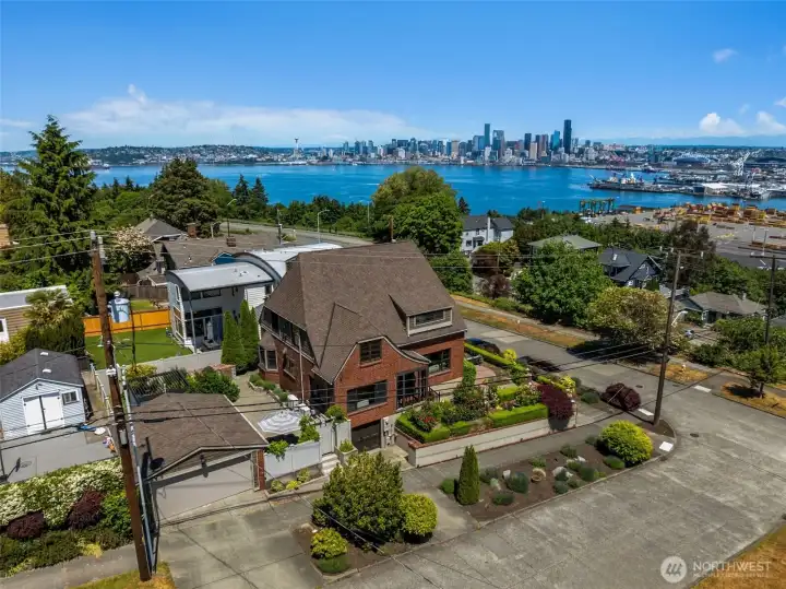 Perched on a prominent corner, atop West Seattle's historic North Admiral residential plateau, this distinguished 1927 brick residence is framed by sweeping views of Elliott Bay, the Seattle skyline, the Cascade Mountains, and Mount Rainier.