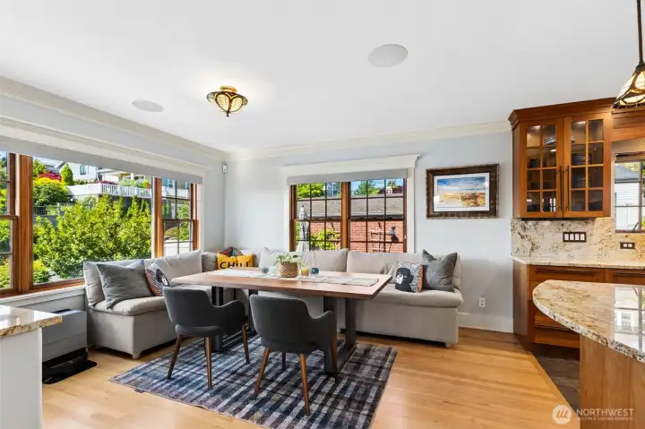 The kitchen flows seamlessly into a sun-filled Morning Room framed by classic wood framed windows, gas fireplace, and a view of Mount Rainier.