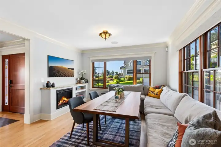 The kitchen flows seamlessly into a sun-filled Morning Room framed by classic wood framed windows, gas fireplace, and a view of Mount Rainier.