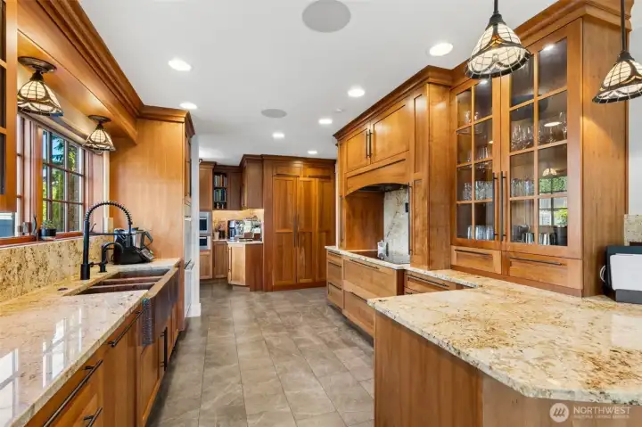 A true Chef's kitchen with Miele appliance package that includes: steam oven, warming drawer, double oven, side-by-side custom panel refrigerator/freezer, dishwasher, 5-zone induction cooktop, and more. Also heated floors!