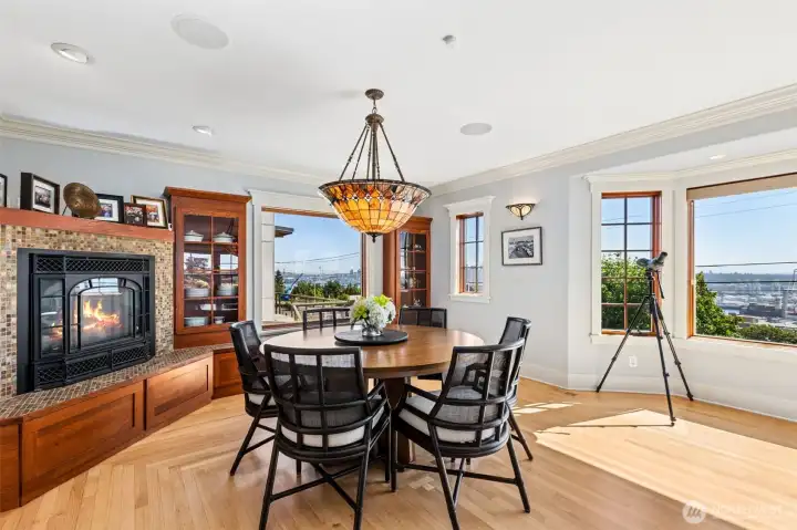 The circular floor plan flows into a living and dining room with sweeping views from the Space Needle across Elliott Bay and the working waterfront to Mount Rainier.