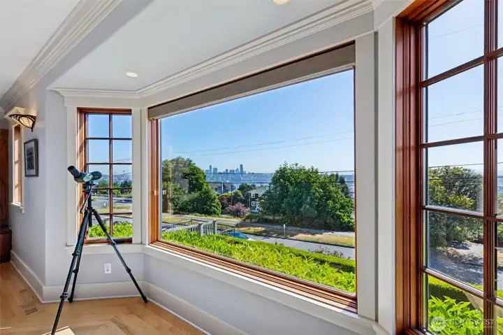 Timeless wood-framed windows frame unforgettable views of Seattle's iconic skyline, and working waterfront.  Filling the living room with natural light and a remarkable sense of connection to the city.