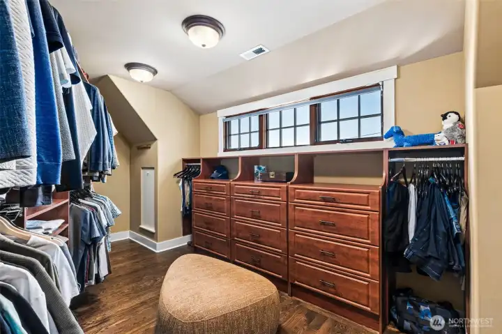Generous walk-in closet with built-ins, and additional eaves storage.