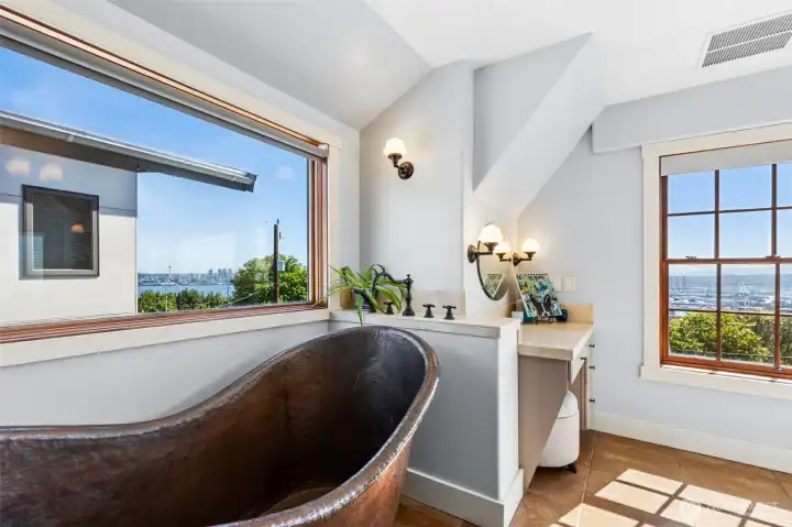 Primary bathroom includes copper soaking tub with views of down town and the Cascade mountains.
