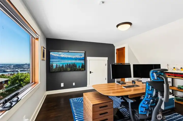 Loft-level bedroom or office features a walk-in closet and stunning city views.