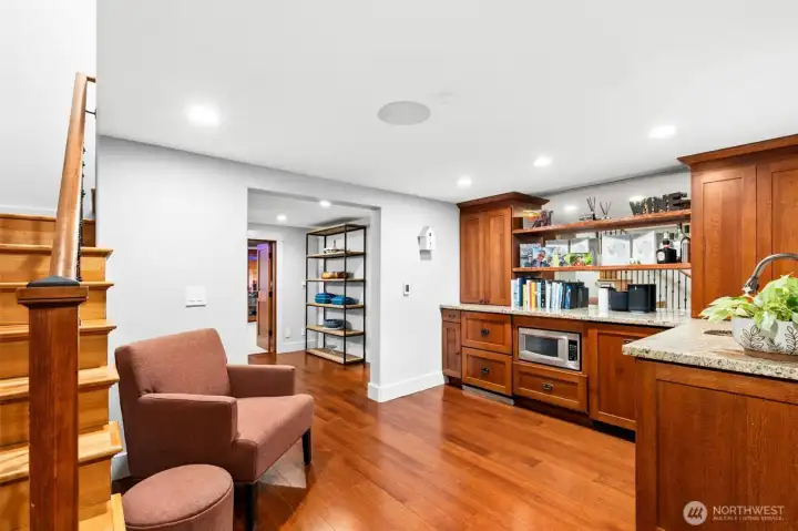 Basement level bar features heated floors and custom panel under counter drawer refrigeration, microwave, dishwaser and trash compactor.