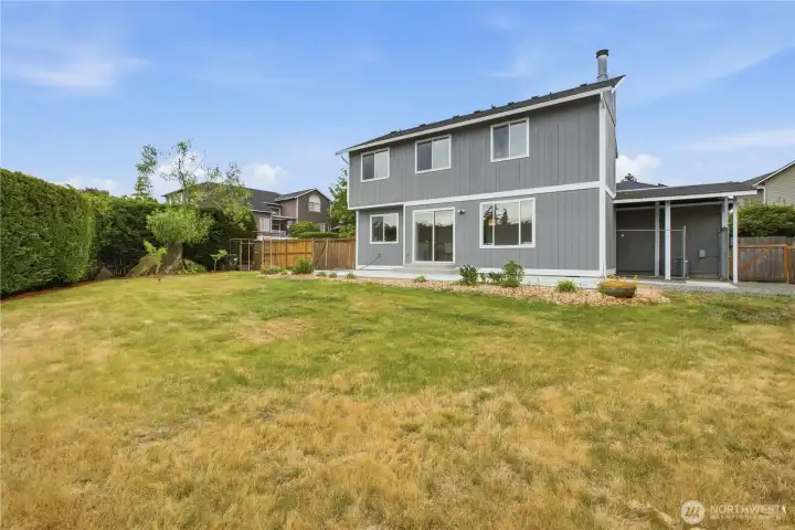Backyard - dog kennel on the right with gated fence on the right.