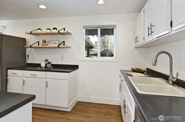 Spacious kitchen with stainless appliances.