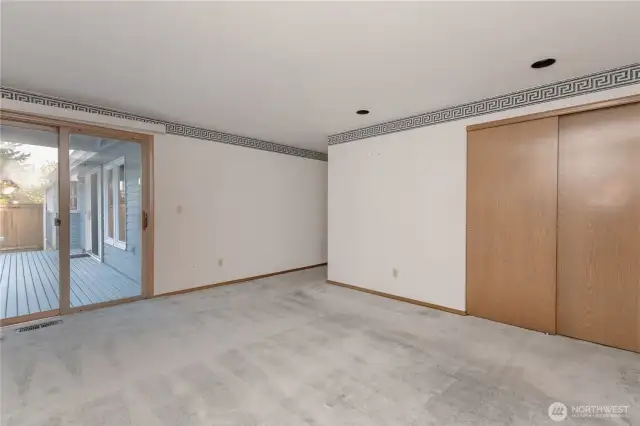 Primary bedroom with sliding door leading to the deck.