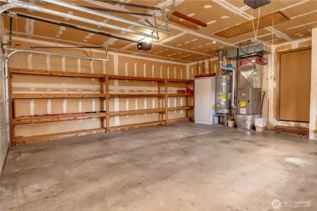Double car garage, gas hot water tank, gas furnace and cabinet storage.