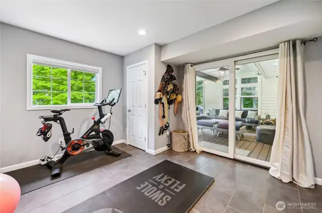 Main floor room with a sliding door to the covered deck. Guest room?