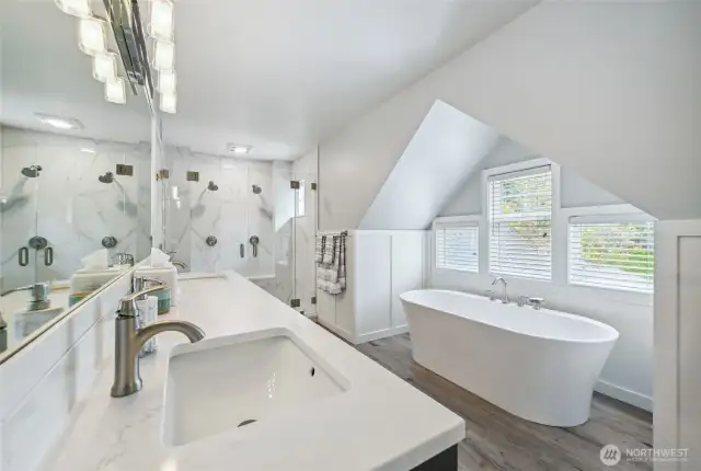 Dual sink vanity and undermount sinks topped with quartz, a free-standing easy to access soaking tub . .  .