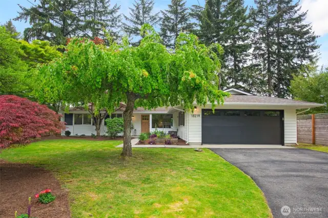 The home sits well back from the street and mature landscaping offers added privacy.