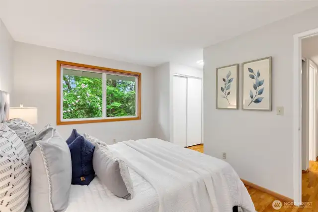 Double closets nestled between the sleeping area and full bathroom.