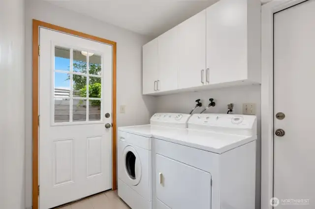 Laundry room situated between bonus room and garage with access to the side yard.
