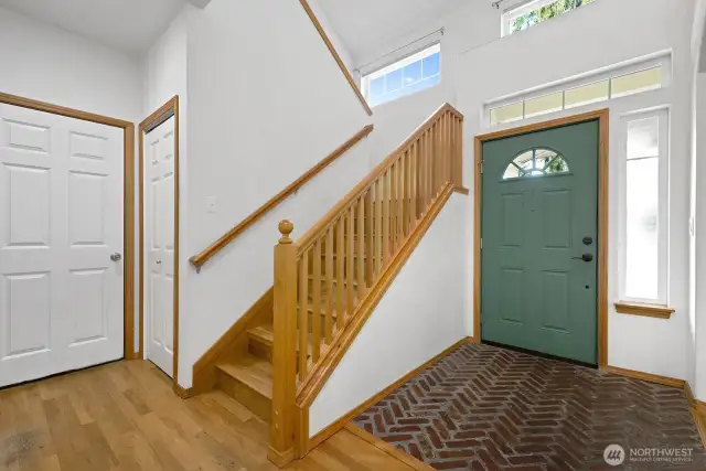 Light and airy entry way that leads upstairs and to garage.