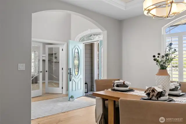 An elegant entry opens to an office space and formal dining.