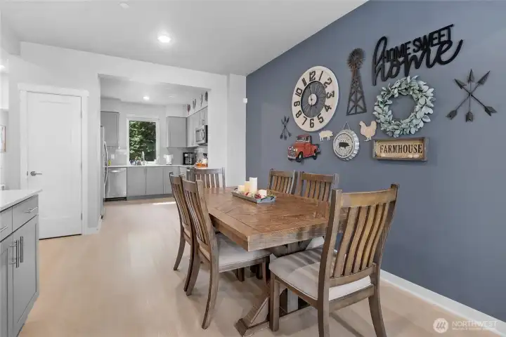 Spacious open living room, dining, kitchen, filled with natural light.