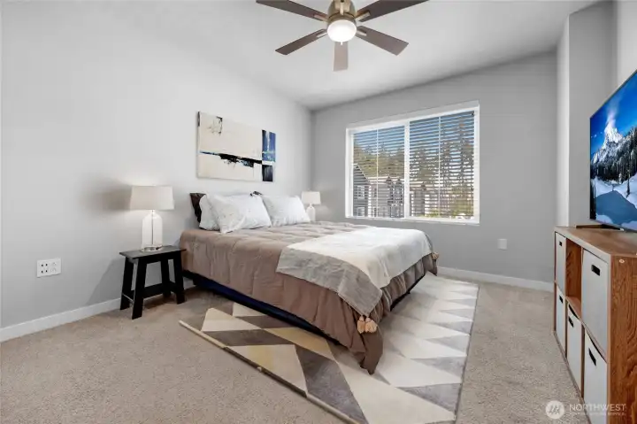 Spacious primary bedroom with natural light.