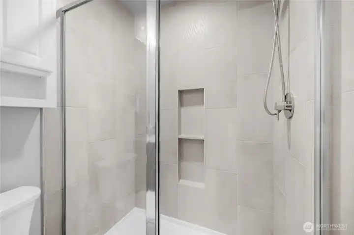 Private ensuite bathroom with modern tile.
