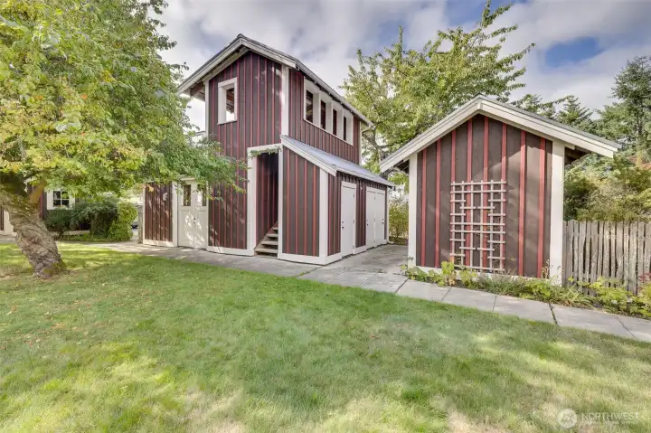 Building on right contains storage units for each cottage. Building on left is the common meeting room below with walkable deck above.