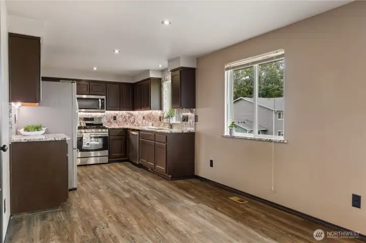 Refined Kitchen with Granite countertops and backsplash.  Wonderful under the counter lighting.