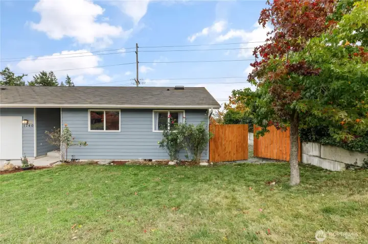 More front yard with double gate to fully fenced backyard