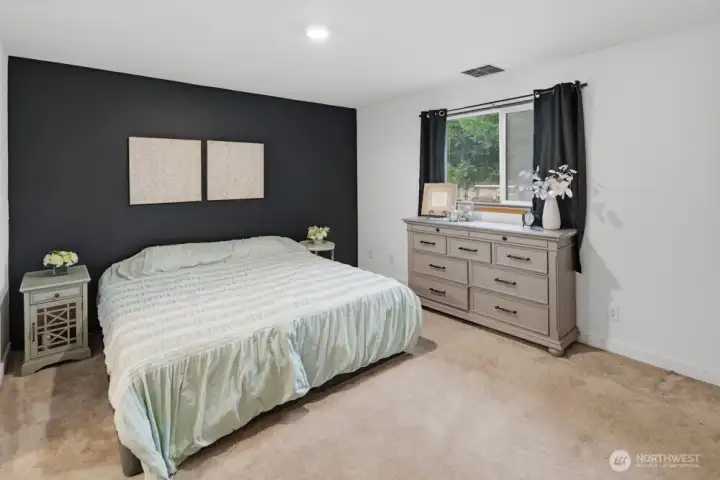 Primary Suite boasts a full ensuite bathroom and views of the backyard