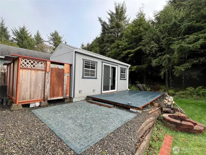 A sweet shed cabin made into a living/bonus area. Also an outside portable toilet inside the fence.