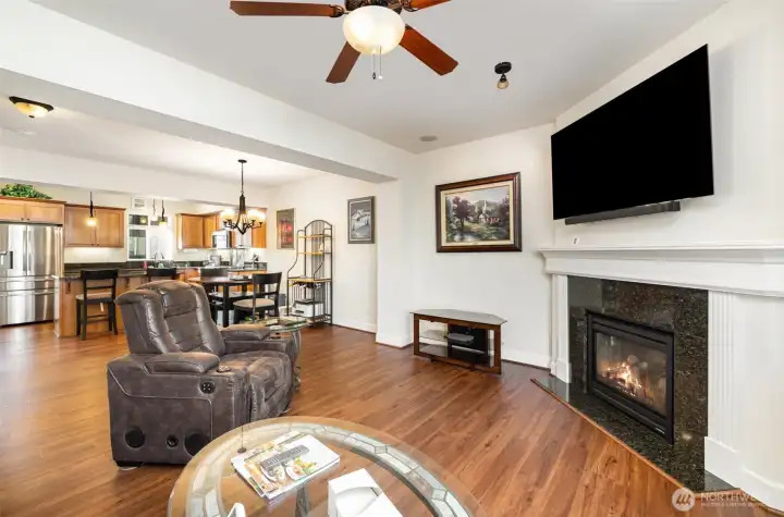 The living room includes built-in speakers and cozy gas fireplace with blower for additional heating.