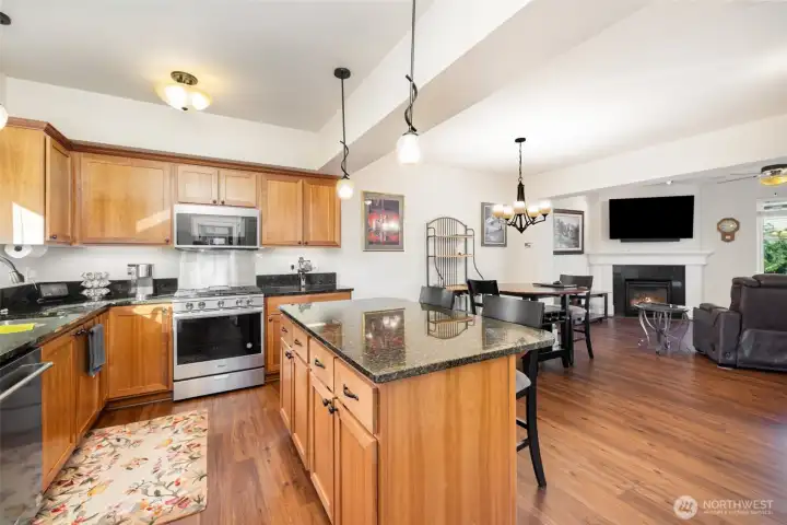 The kitchen shines with stainless steel appliances, granite counters, under cabinet lighting and a large island.