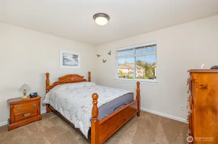 Second upstairs guest bedroom also has a large sliding door closet.