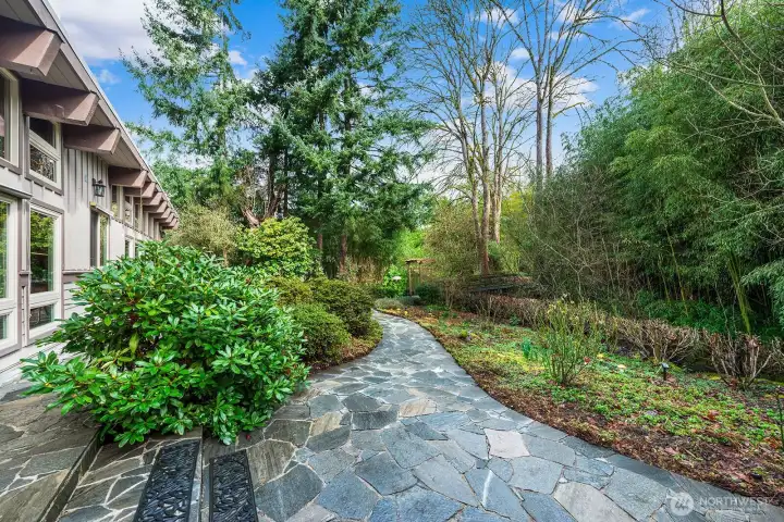 Gorgeous slate walkways wind throughout the low-maintenance native landscaping covering the property.