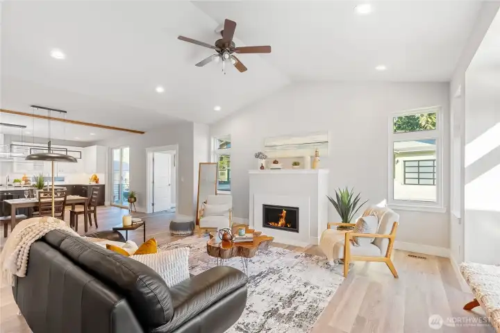 Open floor plan makes it easy to entertain guests. Lots of windows for natural light, tall vaulted ceilings, natural gas fireplace incased in quartz as the focal point of the living room.