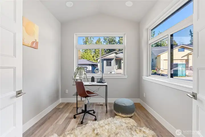 A vaulted private office on the first floor with lots of natural light, and privacy French doors. Or can be used as a reading nook/library, morning fitness or yoga room...