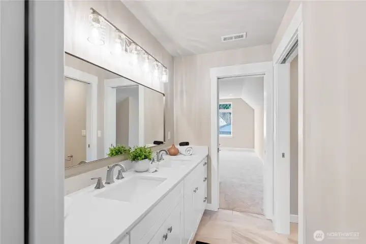 This Jack and Jill bathroom is share between bedrooms #3 and #4, long double sink vanity, with pocket doors on each bedroom for privacy, titled flooring, under cabinet lighting, and a separate toilet and shower room!