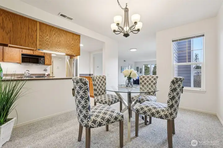 Dining, kitchen and living room are all visible creating easy flow