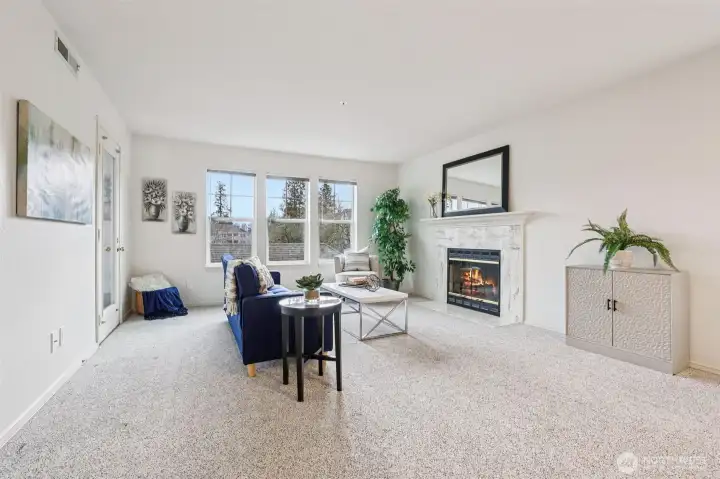 Gorgeous living room with warm fireplace (wood burning) and fresh paint to bring in your own color!