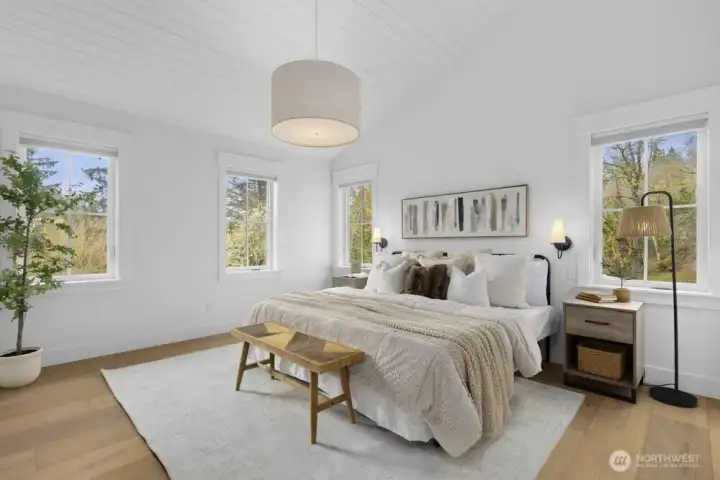 Tranquil primary retreat featuring vaulted, wood-lined ceilings.