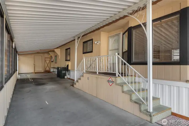 Fully covered carport with work shop in back and access to the private backyard yard offers yard.