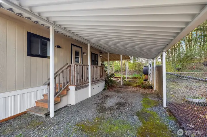 Additional cover parking with deck to the utility room.