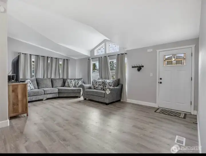 Living area from a second angle, featuring the attractive transom window and ceiling vault.