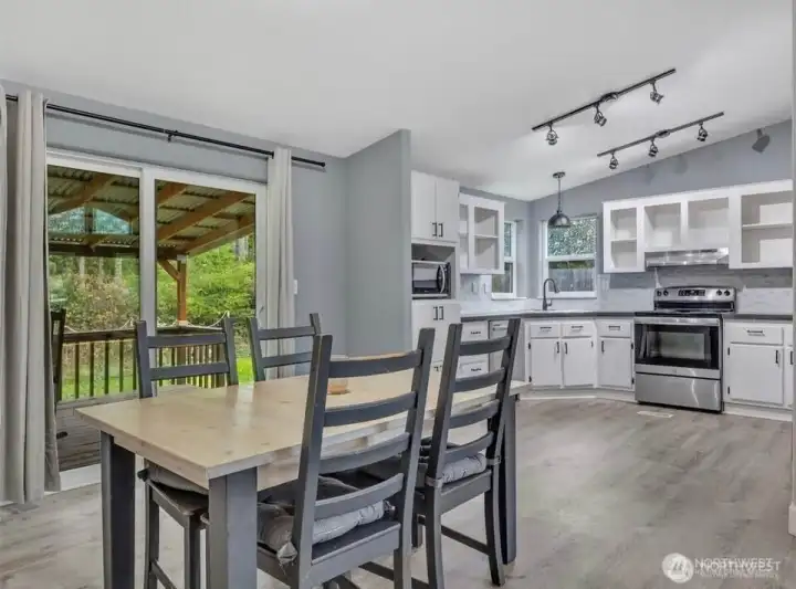 Dining area with slider to a covered back deck—perfect for easy indoor-outdoor living and year-round BBQs, rain or shine.
