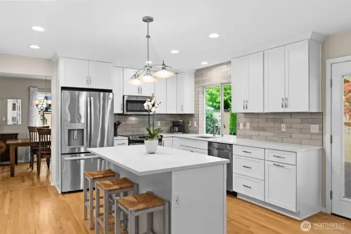 Updated kitchen features quartz countertops, stainless steel appliances, and expansive cabinet storage. Updated kitchen features quartz countertops, stainless steel appliances, and expansive cabinet storage.