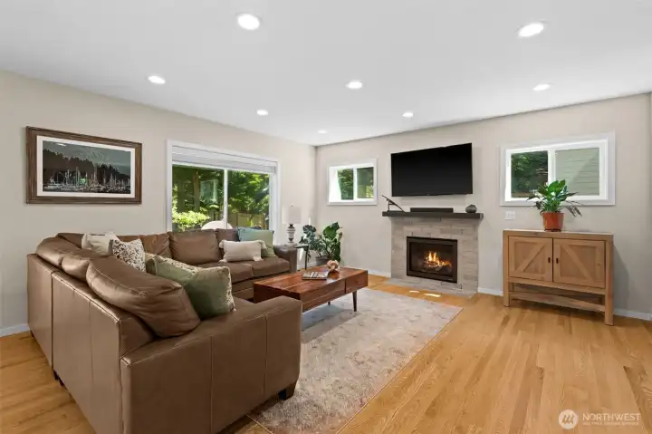Contemporary living area with gas fireplace, expansive seating space, and neutral finishes. Contemporary living area with gas fireplace, expansive seating space, and neutral finishes.